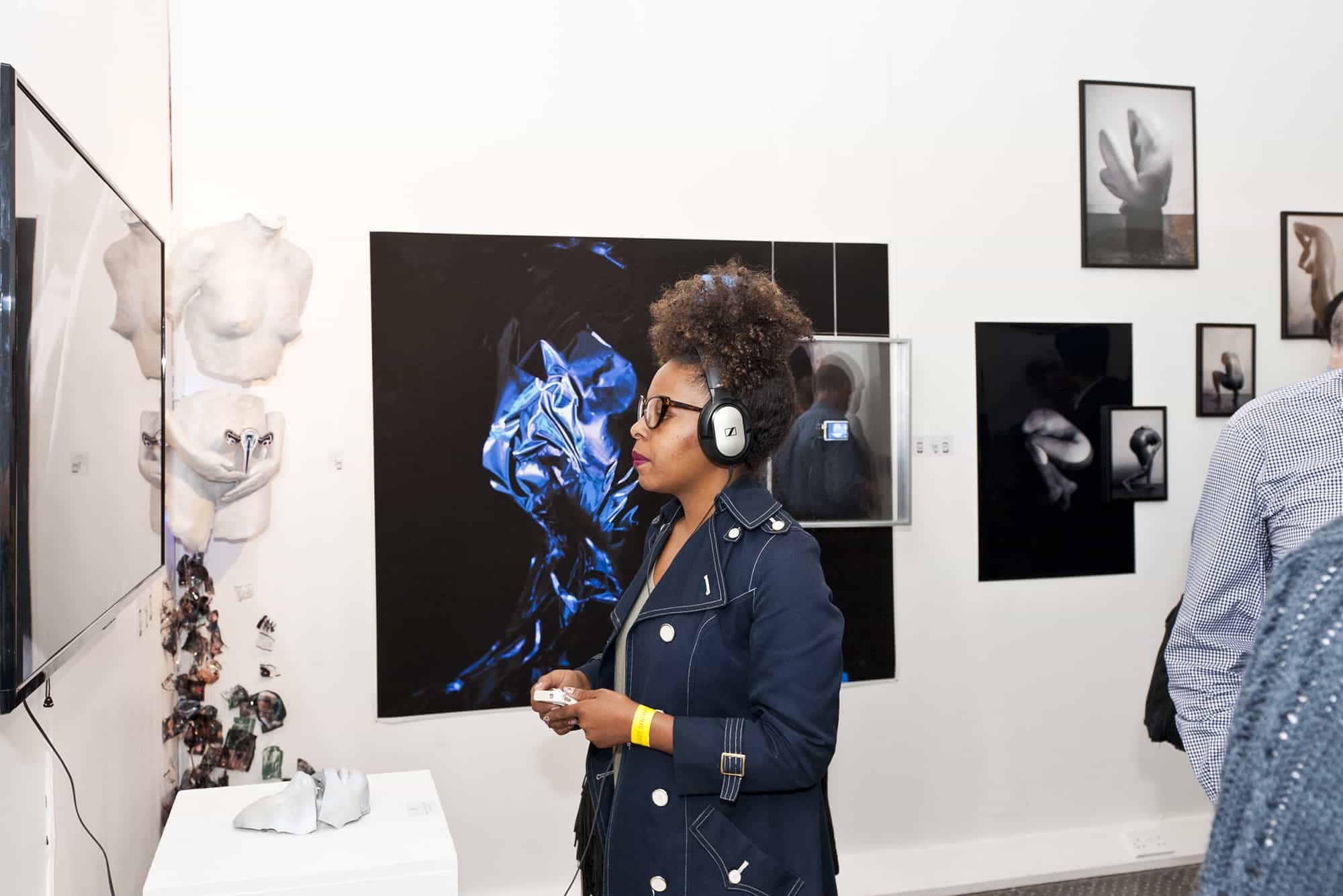 Ana Escobar, Girl with headphones at a private view, London College of Communication, UAL