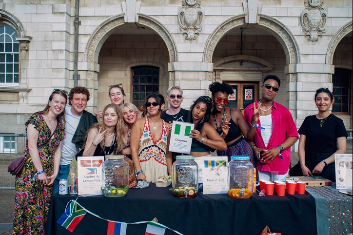 Colleagues pose in front of the GEMS network stall | Photography: Berenice Guzzo